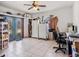 Spacious office features tiled floors, two refrigerators, glass paneled doors, ceiling fan, and a well-lit work area at 7843 Shoupe Rd, Plant City, FL 33565