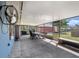 Covered patio boasts ample seating, string lights, fan, and a concrete floor, perfect for outdoor enjoyment at 7843 Shoupe Rd, Plant City, FL 33565