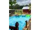 Relaxing pool with inflatable floats and a view of the backyard at 7843 Shoupe Rd, Plant City, FL 33565
