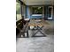 Inviting screened porch with wooden furniture, offering a relaxing outdoor space at 7843 Shoupe Rd, Plant City, FL 33565