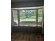 Inviting window seat offering serene views of the expansive yard and mature trees at 7843 Shoupe Rd, Plant City, FL 33565