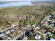 An aerial view of the neighborhood with tree coverage and a lake nearby at 811 Helmsman Way, Palm Harbor, FL 34685