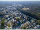 Aerial view of neighborhood with a mix of tree coverage, manicured lawns, and well-maintained streets at 811 Helmsman Way, Palm Harbor, FL 34685
