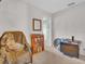 Neutral bedroom featuring a comfortable chair, bookcase, and entertainment center at 811 Helmsman Way, Palm Harbor, FL 34685