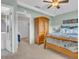 Calming bedroom featuring a decorative bed and wood armoire, complemented by soft pastel walls at 811 Helmsman Way, Palm Harbor, FL 34685
