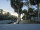 Community boat ramp and adjacent information kiosk surrounded by mature palm trees at 811 Helmsman Way, Palm Harbor, FL 34685