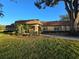 Community building with a well-manicured lawn and mature landscaping at 811 Helmsman Way, Palm Harbor, FL 34685