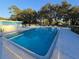 Large and inviting community pool with ample seating and a mural at 811 Helmsman Way, Palm Harbor, FL 34685
