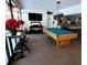 Open community room with a pool table, piano, bar seating, and kitchen at 811 Helmsman Way, Palm Harbor, FL 34685