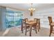 Bright dining room with patio access, chandelier, and seating for four at 811 Helmsman Way, Palm Harbor, FL 34685