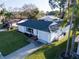 Charming single-story home with a well-manicured lawn, attached garage and lovely landscaping at 811 Helmsman Way, Palm Harbor, FL 34685