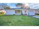 Charming single-story home with a well-maintained lawn and a bright, welcoming facade at 811 Helmsman Way, Palm Harbor, FL 34685