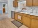 Charming kitchen with stainless steel appliances, light wood cabinets, and light countertops at 811 Helmsman Way, Palm Harbor, FL 34685