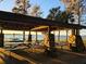 Community picnic pavilion with stone supports and long picnic tables with a lake view for residents to enjoy at 811 Helmsman Way, Palm Harbor, FL 34685