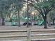 Community playground featuring modern equipment, surrounded by mature trees and green space at 811 Helmsman Way, Palm Harbor, FL 34685