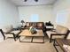 Cozy sitting area with couch, chairs, coffee table and plenty of natural light for reading and relaxation at 811 Helmsman Way, Palm Harbor, FL 34685