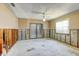 The unfinished basement features exposed framework, a window with blinds, a fan and an adjacent sliding glass door at 8304 Gulf Way, Hudson, FL 34667