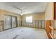 The unfinished basement features exposed framework, a window with blinds, a fan and an adjacent sliding glass door at 8304 Gulf Way, Hudson, FL 34667