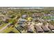 Aerial view of a residential neighborhood with a lake, featuring tidy landscaping and quiet streets at 8329 Moccasin Trail Dr, Riverview, FL 33578