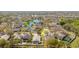 Aerial view of home in a community near a pond with mature trees and green spaces at 8329 Moccasin Trail Dr, Riverview, FL 33578