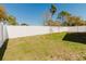 Wide view of fenced-in backyard with young trees and green grass at 8329 Moccasin Trail Dr, Riverview, FL 33578