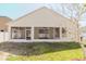 View of the backyard with screened-in patio and mature tree at 8329 Moccasin Trail Dr, Riverview, FL 33578