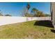 Backyard with privacy fence, grass, and young trees at 8329 Moccasin Trail Dr, Riverview, FL 33578