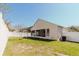 View of the backyard with screened-in patio and green grass at 8329 Moccasin Trail Dr, Riverview, FL 33578