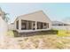 View of the backyard with screened-in patio and white fence at 8329 Moccasin Trail Dr, Riverview, FL 33578