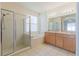 Bathroom showcasing a glass shower enclosure, tub, and double vanity at 8329 Moccasin Trail Dr, Riverview, FL 33578