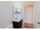 Bathroom with a sink vanity and door to the toilet/shower; wood look flooring at 8329 Moccasin Trail Dr, Riverview, FL 33578