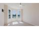 Bright bedroom with bay windows, neutral carpet, and a wall-mounted TV setup at 8329 Moccasin Trail Dr, Riverview, FL 33578