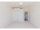 Bedroom featuring closet, neutral carpet, and a door leading to another room at 8329 Moccasin Trail Dr, Riverview, FL 33578