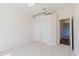 Bedroom featuring closet, neutral carpet, and a door leading to another room at 8329 Moccasin Trail Dr, Riverview, FL 33578