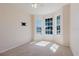 Bright bedroom with bay windows, neutral carpet, and a wall-mounted TV setup at 8329 Moccasin Trail Dr, Riverview, FL 33578