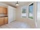Breakfast nook featuring bright windows, tile floor, closet storage and light wood cabinets at 8329 Moccasin Trail Dr, Riverview, FL 33578