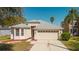 Charming single-Gathering home showcasing a two-car garage and manicured lawn at 8329 Moccasin Trail Dr, Riverview, FL 33578