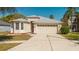 Charming single-Gathering home showcasing a two-car garage and manicured lawn at 8329 Moccasin Trail Dr, Riverview, FL 33578