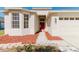 Inviting front entrance featuring a red door and well-maintained landscaping at 8329 Moccasin Trail Dr, Riverview, FL 33578