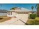 Charming single-Gathering home showcasing a two-car garage and manicured lawn at 8329 Moccasin Trail Dr, Riverview, FL 33578
