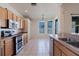 Bright kitchen with stainless steel appliances, tile floors and light wood cabinets and a breakfast nook with bright windows at 8329 Moccasin Trail Dr, Riverview, FL 33578