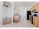 Open kitchen view with stainless steel appliances, light wood cabinets, and access to the living area at 8329 Moccasin Trail Dr, Riverview, FL 33578
