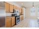 Bright kitchen featuring stainless steel appliances, light wood cabinets and tile flooring with breakfast nook at 8329 Moccasin Trail Dr, Riverview, FL 33578