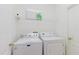 Convenient laundry room with a full-size washer and dryer for easy chore days at 8329 Moccasin Trail Dr, Riverview, FL 33578