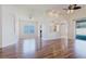 Bright living space with wood floors, recessed lighting, and arched entryways to the kitchen at 8329 Moccasin Trail Dr, Riverview, FL 33578