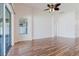 Living area with wood floors and sliding glass doors leading to outdoor space at 8329 Moccasin Trail Dr, Riverview, FL 33578