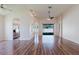 Open-concept living area featuring wood floors, arched doorways, and abundant natural light at 8329 Moccasin Trail Dr, Riverview, FL 33578