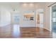 Open-concept living area with wood floors and an arched opening to the kitchen at 8329 Moccasin Trail Dr, Riverview, FL 33578