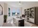 Bright office space with bay window, sleek desk, and built-in shelving for organization at 8329 Moccasin Trail Dr, Riverview, FL 33578