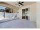 Covered patio features ceiling fan and sliding glass door to indoors at 8329 Moccasin Trail Dr, Riverview, FL 33578